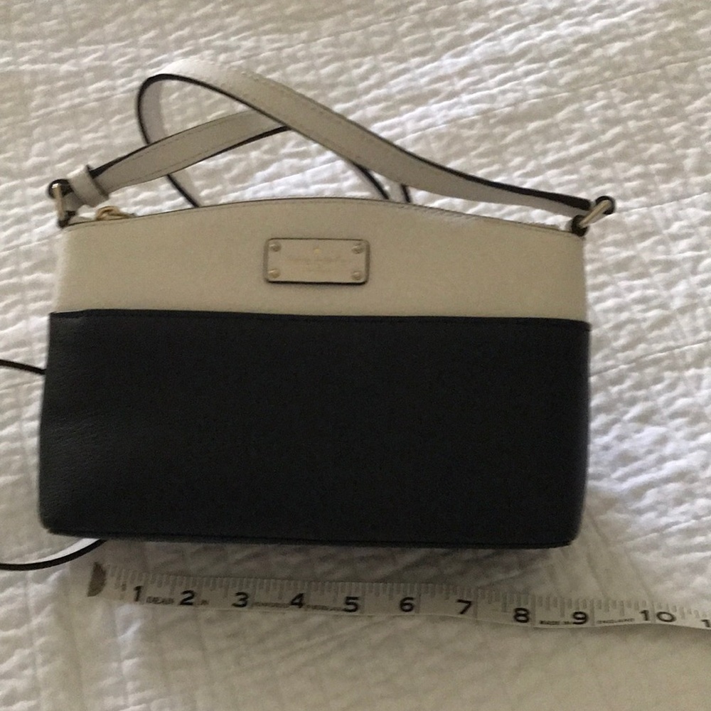 Kate spade black and white purse with adjustable strap and front pocket